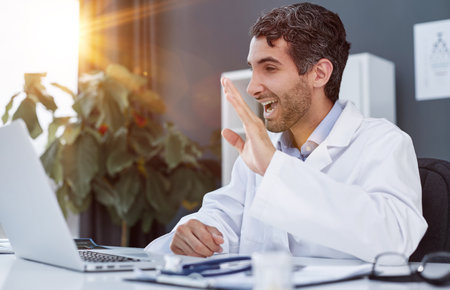 Doctor explaining through video call in clinicの写真素材