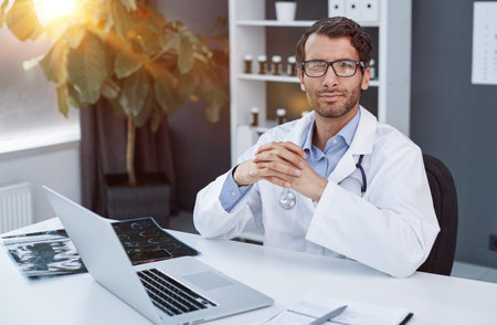 Portrait of happy arabic doctor posing at clinic