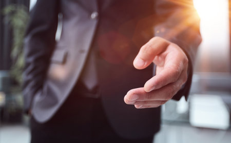 Elegant business man offering a handshake in the officeの写真素材