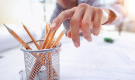 A close-up of male architect working on a project of a residential buildingの写真素材