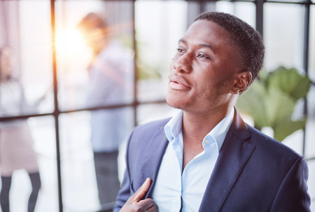 Head shot close up young thoughtful african american businessman entrepreneur looking away.の写真素材