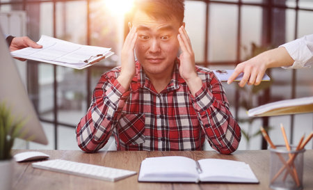 Upset stressed young guy coping with severe headache,の写真素材