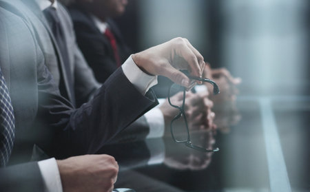 Close up of male hands holding a pair of glassesの写真素材