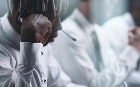 Black sales agents wearing a headset while working in a call centre.の写真素材