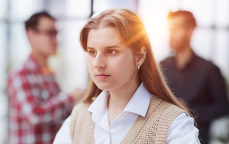 Woman reading important business documents sitting at the table in the officeの写真素材