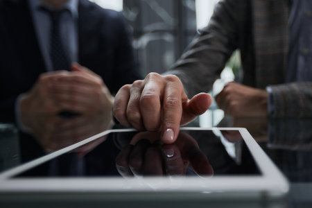 businessman pressing his finger on the screen of the digital tabの写真素材