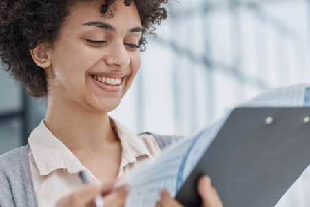 woman in the office looking through paper documents
