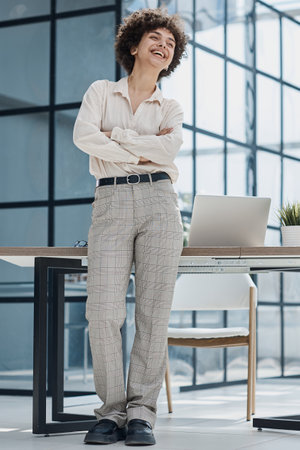 girl in the office smiles expresses success and leadership is thinking about successの写真素材