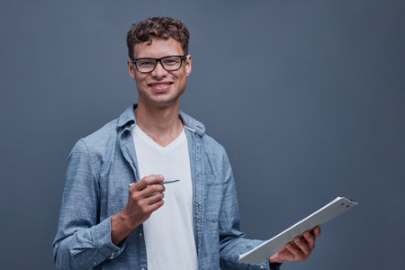 portrait of a young man on a gray backgroundの写真素材