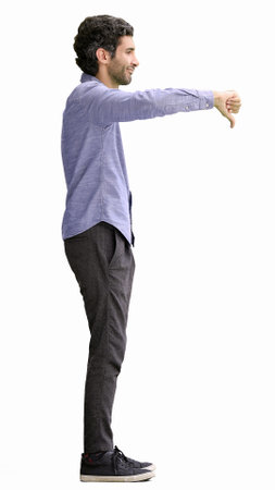 young man in full growth. isolated on white background showing bad sign with thumb