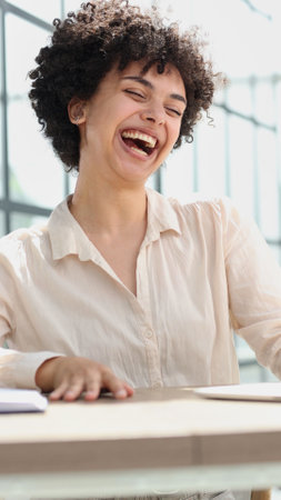 Happy excited young woman student or employee, office worker winner using laptopの写真素材
