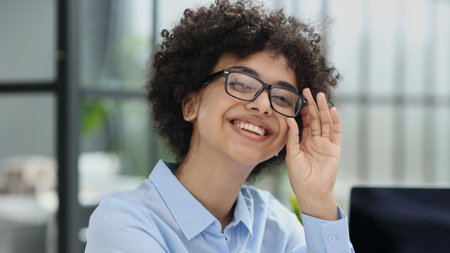 girl in the office smiles expresses success and leadership is thinking about success