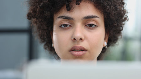 Portrait of Young Successful Caucasian Businesswoman Sitting at Desk Working on Laptopの写真素材