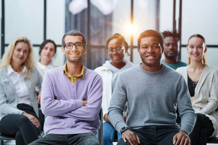 diverse young people sitting on chairs in the conference room.