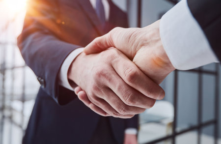 Business partners shaking hands in meeting hallの写真素材