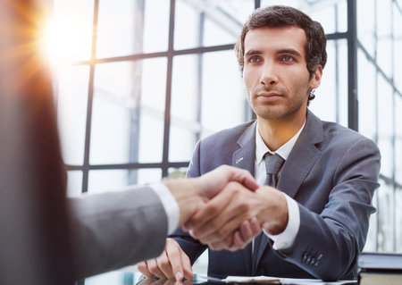close up.businessman shaking hands with his business partnerの写真素材
