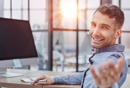 Welcome to the team. business man shaking hands and smiling while sitting at the tableの写真素材
