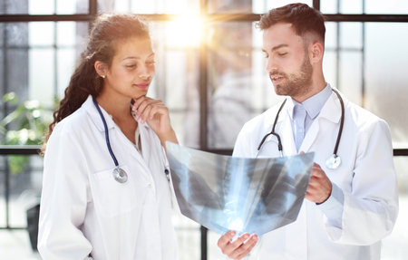 Two busy doctors working with papers and xray imagesの写真素材