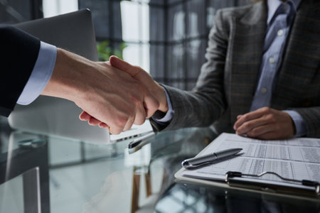 Agent and client shaking hands after signed document and done business deal for transfer right of property.の写真素材