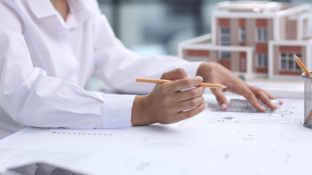 female architect designer examines house layoutの写真素材