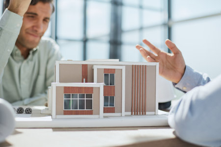 designer and client discuss the project of a house under construction. look at the layout