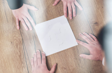 Above view of business team looking at paper during meeting and discussing itの写真素材
