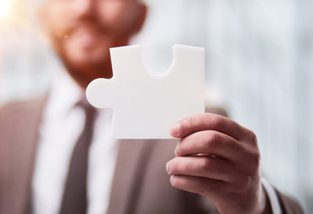 happy businessman holding a puzzle in his hands. Business decisions, success and strategy.の写真素材