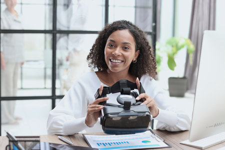 Girl in VR glasses of virtual reality with gamepad playing game
