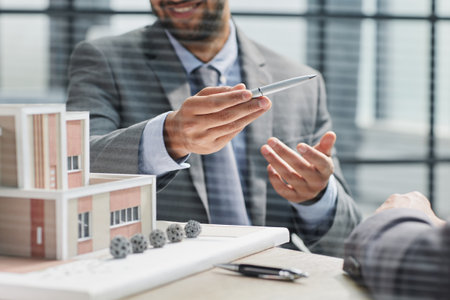 two successful people are discussing a house construction project. layout on the tableの写真素材