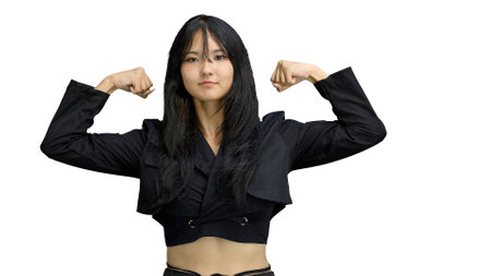 A girl in black clothes, on a white background, close-up, shows strengthの写真素材