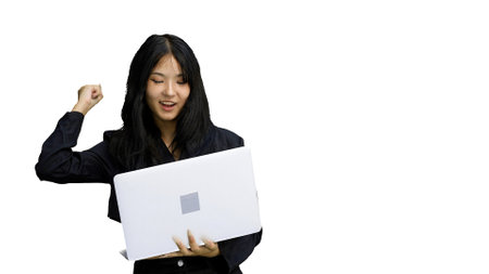 A girl in black clothes, on a white background, close-up, with a laptopの写真素材