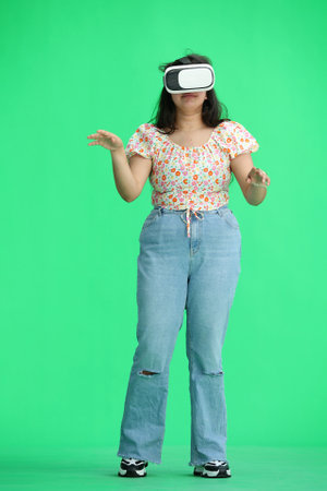 A woman, on a green background, full-length, wearing virtual glasses