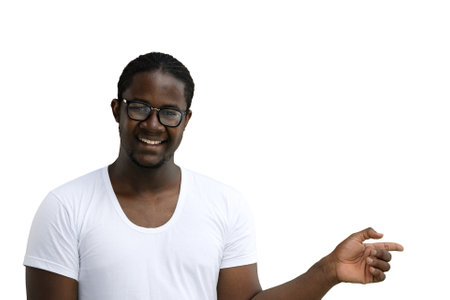 A man in a white T-shirt on a White background close-up points his fingers to the sideの写真素材