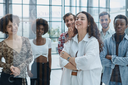 business woman with her staff in background at office