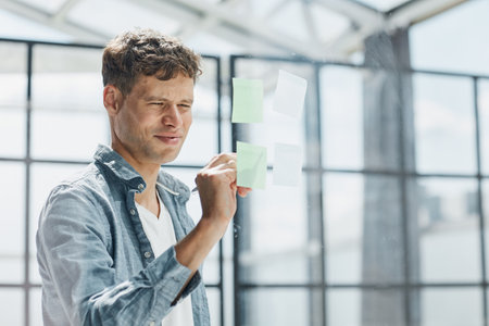 Businessman, sticky notes and work schedule for project planningの写真素材