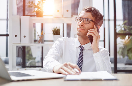 Man accountant or business lawyer talking on smartphoneの写真素材