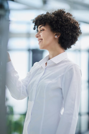 woman working on project plan using sticky papers notes on glass