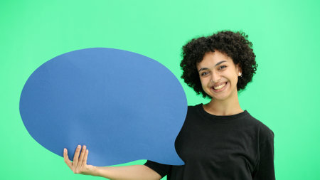Woman, close-up, on a green background, blue comment mark