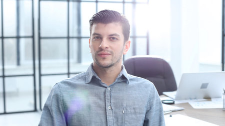 A male office worker looks at the camera in close-upの写真素材