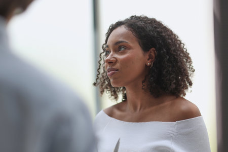 Negotiations in the office. A young woman talks with colleagues