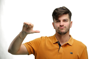 A man, close-up, on a white background, shows his finger downの写真素材