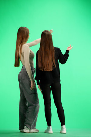 A women, in full-length, on a green background, talkingの写真素材