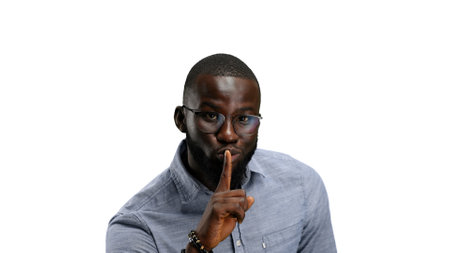 A man, close-up, on a white background, shows a sign of silence