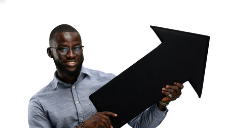 A man, close-up, on a white background, points an arrow to the side