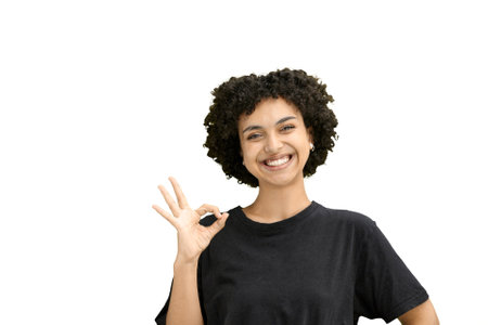 A woman, close-up, on a white background, shows an ok sign