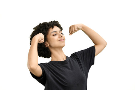 A woman, close-up, on a white background, shows strength