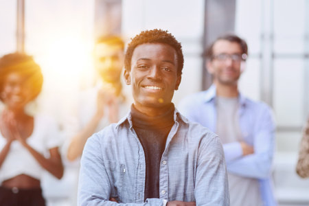 smiling African American business man with executives working in background