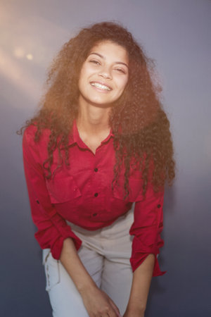Close up view. Beautiful girl sincerely smiling on a gray backgroundの写真素材