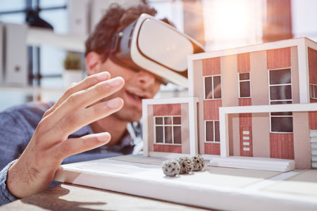 man sits in the office of a realtor and looks at the layout of the apartment in virtual reality...