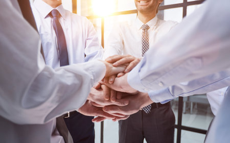 Close up on colleagues hands all together